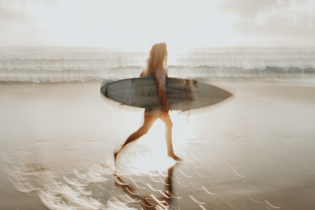 Blurry image showing motion of a surfer running
