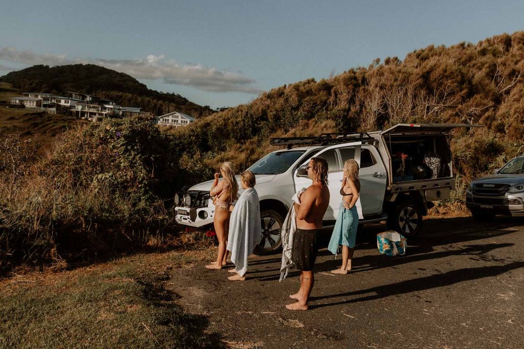 Family checking the surf back to their car.